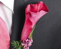 This prom boutonniere features a simple calla lily with hints of green, purple and blue ribbon and wire.