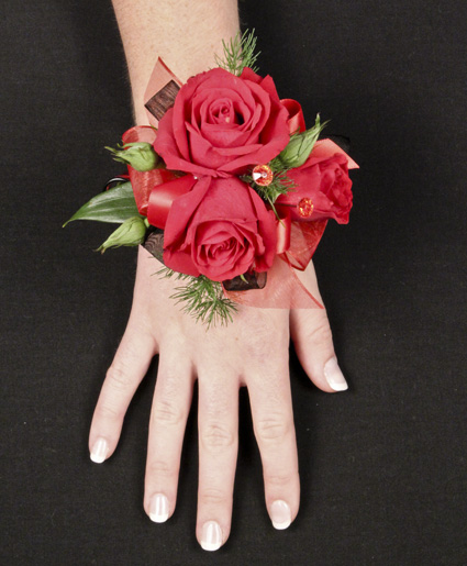 This elegant red corsage is beautiful with the hint of green, red roses and ribbon. This is great for any wedding or prom.