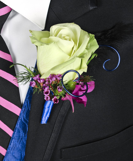 This prom boutonniere is so fun with the light green tinted rose, accents of purple flowers and the blue wire and ribbon.