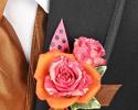 This orange and pink prom corsage features an orange flower with a pink flower inside of it to make a great contrast of colors. Plus, the added accent of the polka dot & orange ribbon makes it stand out.