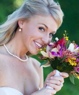 A wedding bouquet adds a pop of color when held against a traditional wedding dress.  